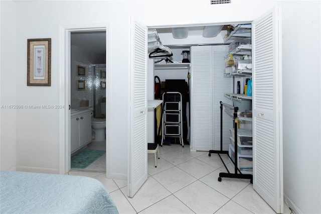 interior space featuring ensuite bathroom and light tile patterned floors