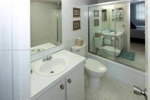 full bathroom with vanity, enclosed tub / shower combo, tile patterned flooring, and toilet