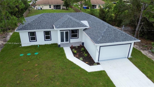 single story home featuring a garage and a front lawn