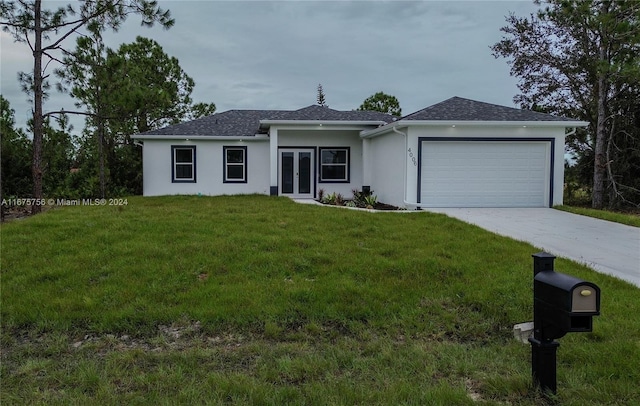 ranch-style home featuring a garage and a front yard