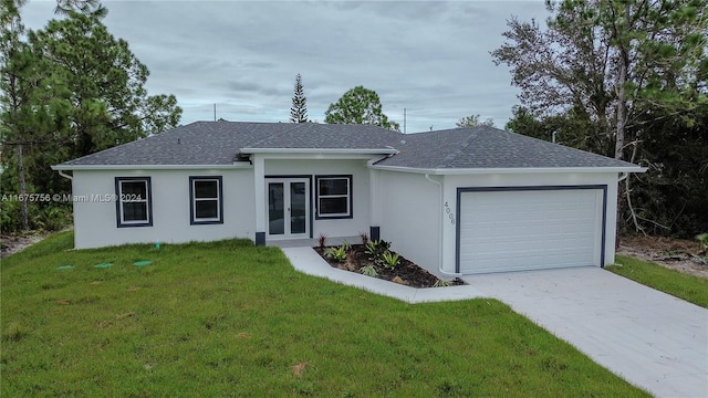 ranch-style home with a garage and a front lawn