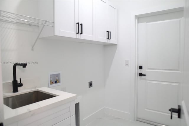 laundry area featuring electric dryer hookup, cabinets, sink, and washer hookup