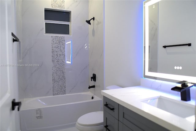 full bathroom with vanity, toilet, and tiled shower / bath combo