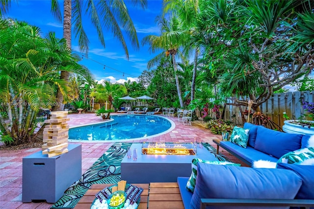 view of swimming pool with outdoor lounge area and a patio