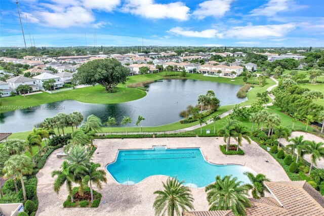 view of pool with a patio and a water view