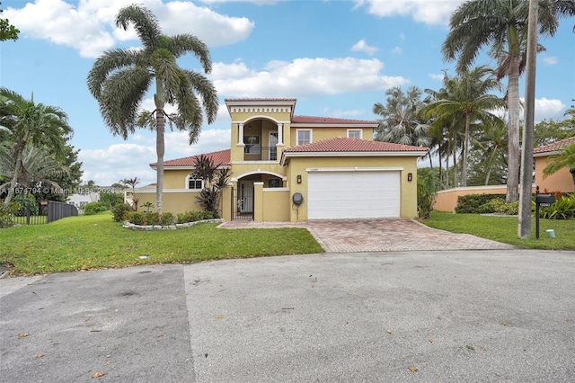 mediterranean / spanish-style house featuring a garage and a front yard