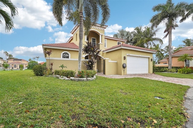 mediterranean / spanish house with a garage and a front yard