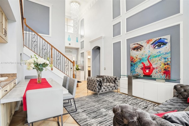 dining room featuring a high ceiling and light tile patterned flooring