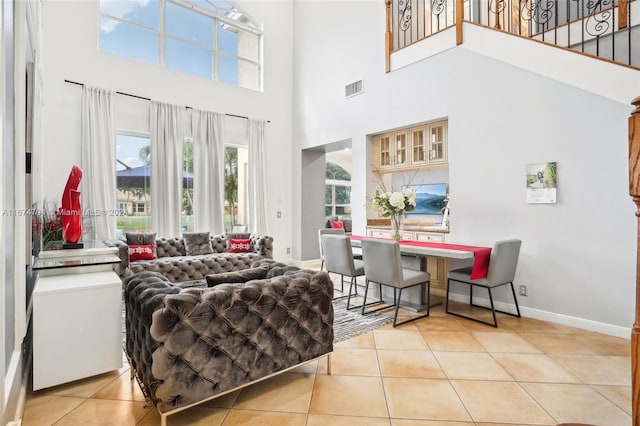 living room featuring a high ceiling and light tile patterned floors