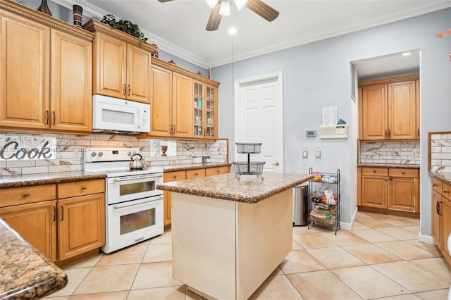 kitchen with light tile patterned flooring, tasteful backsplash, ornamental molding, white appliances, and a center island