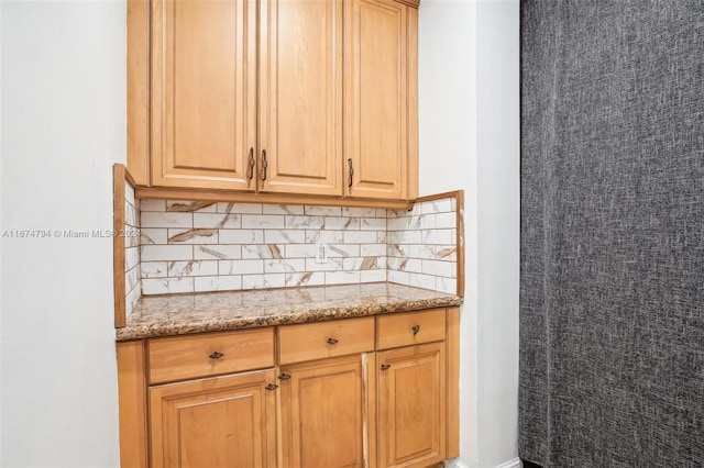 kitchen with backsplash and light stone counters