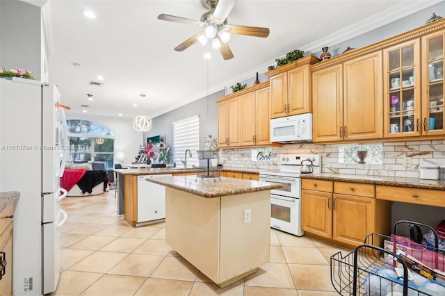 kitchen featuring light stone counters, ornamental molding, white appliances, a center island, and pendant lighting