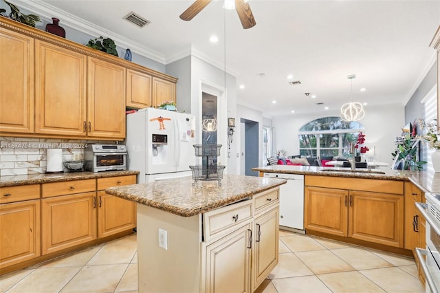 kitchen featuring sink, ornamental molding, a kitchen island, pendant lighting, and white appliances