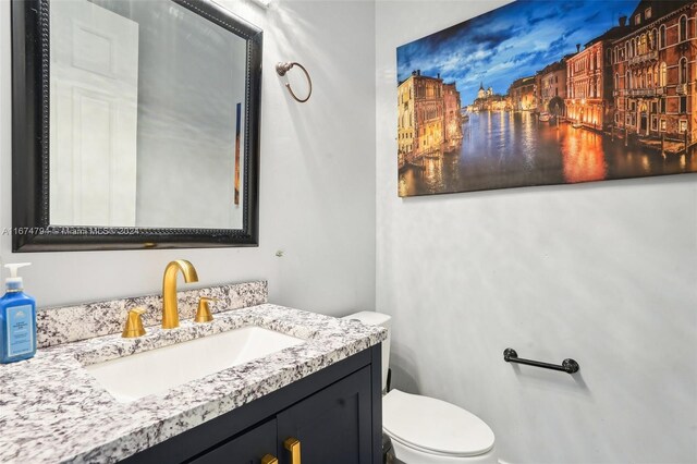 bathroom featuring vanity and toilet