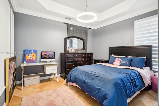 bedroom with tile patterned floors, crown molding, and a tray ceiling