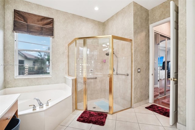 bathroom featuring tile patterned floors and separate shower and tub