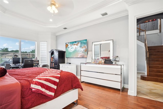 bedroom with ceiling fan, light hardwood / wood-style floors, and crown molding