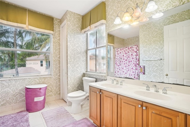 bathroom featuring toilet, vanity, tile patterned floors, and a shower with curtain