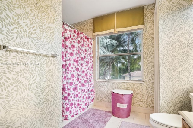 bathroom with toilet, a shower with shower curtain, and tile patterned flooring