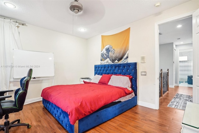 bedroom with hardwood / wood-style floors and ceiling fan