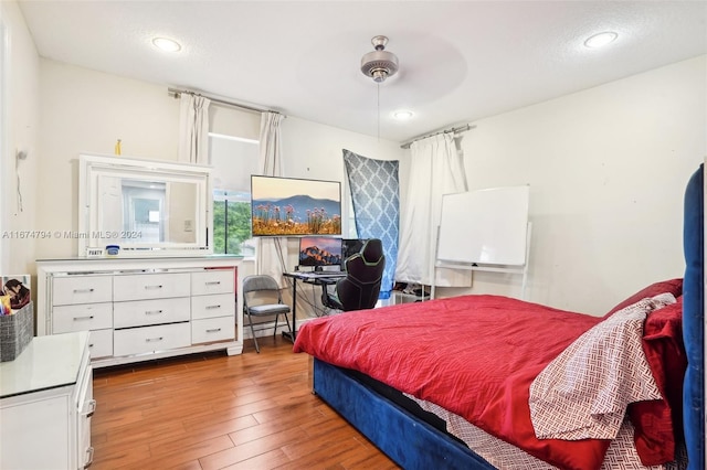 bedroom with hardwood / wood-style floors and ceiling fan