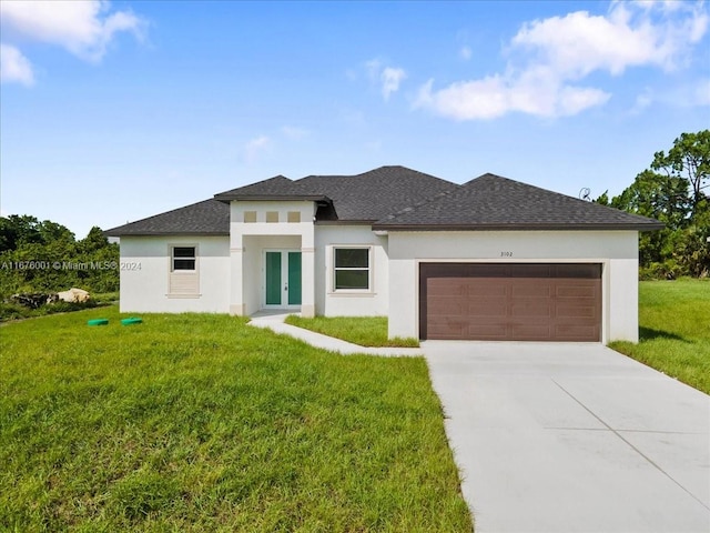 prairie-style home with a garage and a front yard