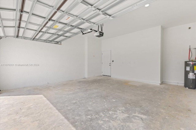 garage with a garage door opener and electric water heater