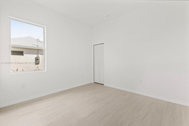 unfurnished room with plenty of natural light and light hardwood / wood-style floors