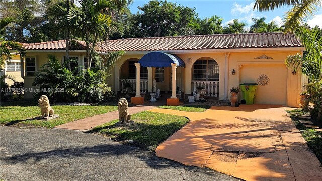 mediterranean / spanish-style house featuring a front lawn