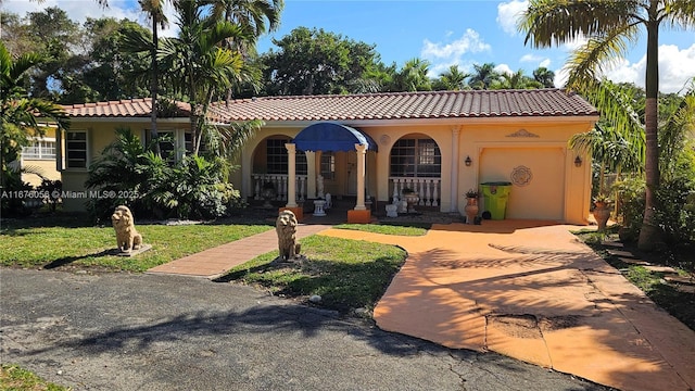 mediterranean / spanish-style home with a garage and a front yard