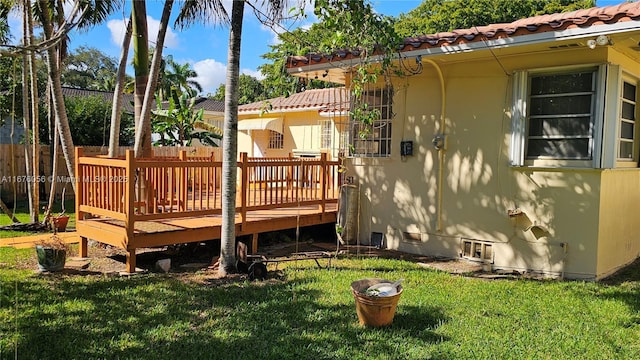 wooden deck with a lawn