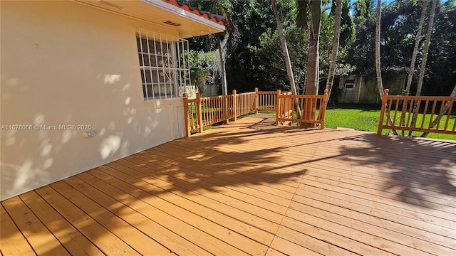 wooden deck with a yard