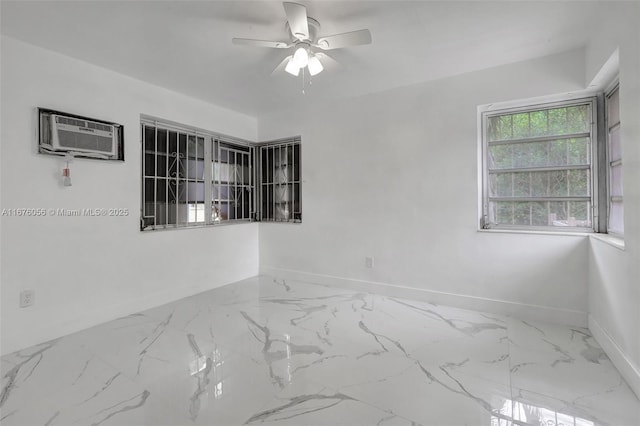 empty room featuring a wall mounted AC and ceiling fan