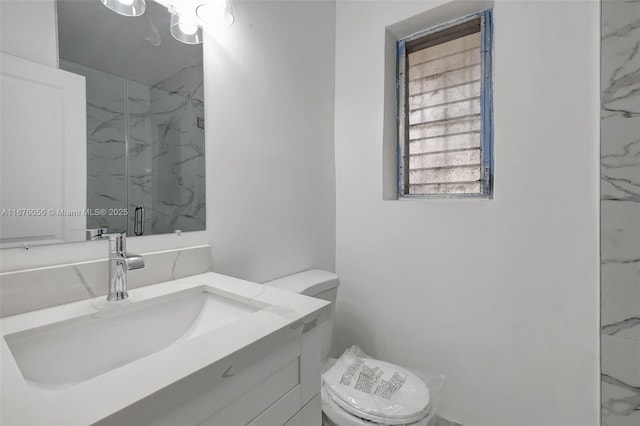 bathroom with vanity, an enclosed shower, and toilet