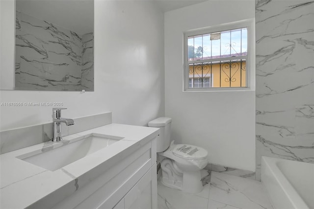 bathroom with a tub to relax in, vanity, and toilet