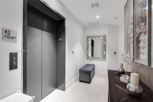 bathroom featuring wood-type flooring and elevator