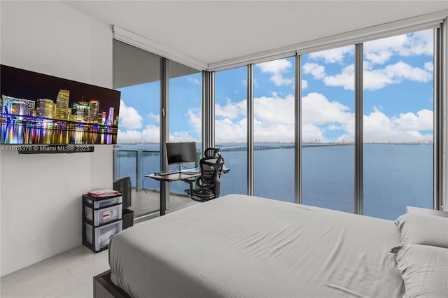 bedroom with multiple windows and floor to ceiling windows