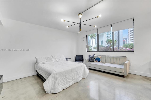 bedroom featuring an inviting chandelier, multiple windows, and concrete flooring