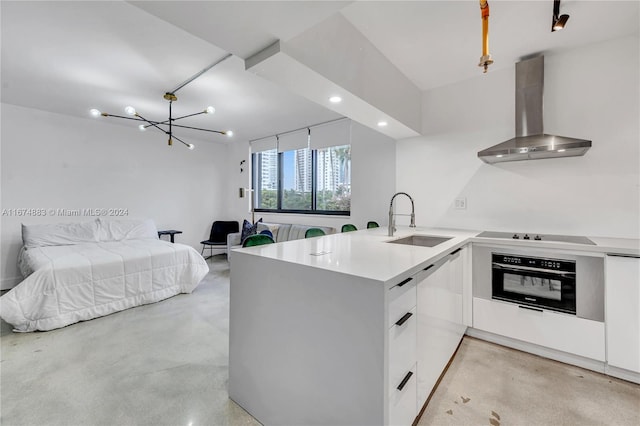 kitchen with black appliances, wall chimney exhaust hood, sink, kitchen peninsula, and white cabinetry