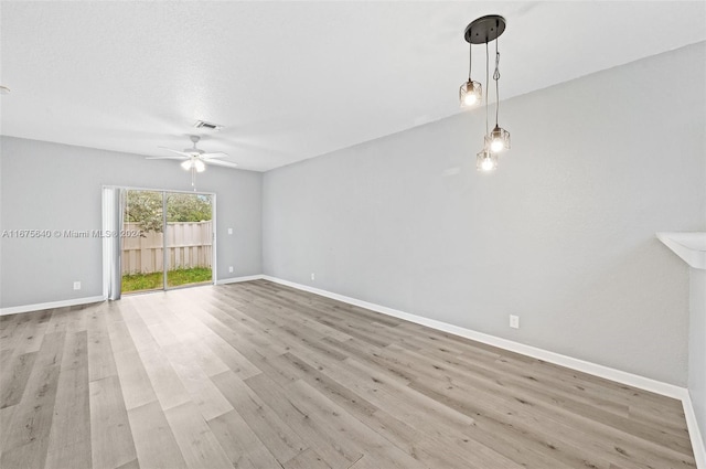 spare room with ceiling fan and light wood-type flooring