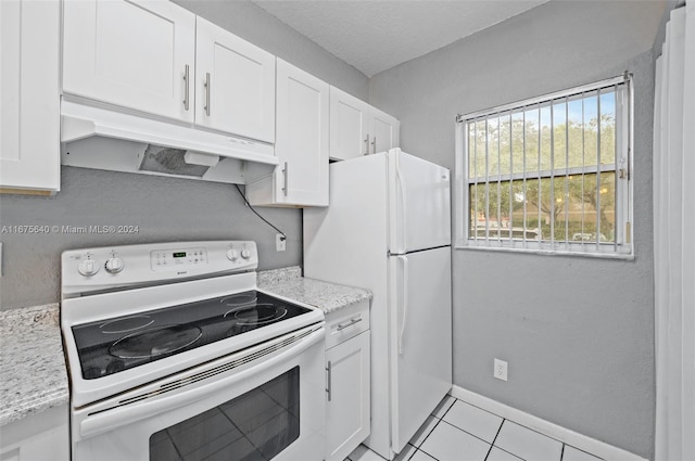 kitchen with white cabinetry, light stone counters, white appliances, and light tile patterned floors