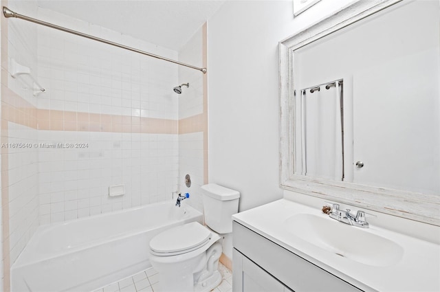 full bathroom with vanity, toilet, tile patterned flooring, and tiled shower / bath