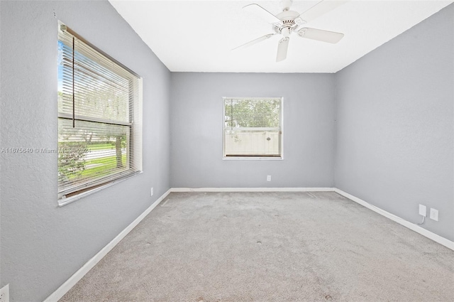 carpeted empty room featuring ceiling fan