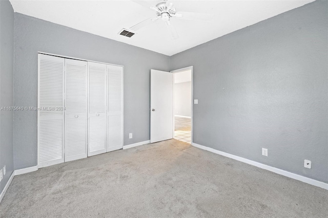 unfurnished bedroom featuring a closet, ceiling fan, and light colored carpet