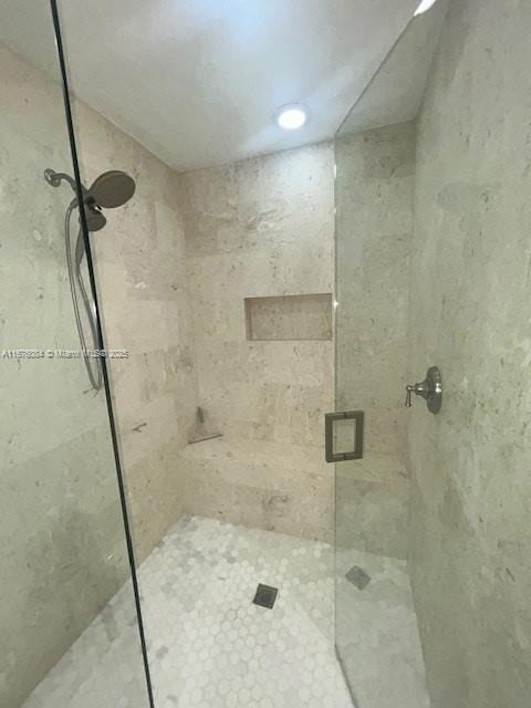 bathroom with a shower with door