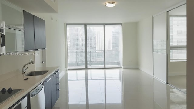 kitchen with black electric stovetop, light countertops, gray cabinetry, a sink, and dishwasher