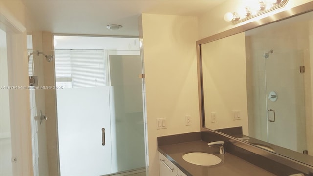 full bathroom with a shower stall and vanity