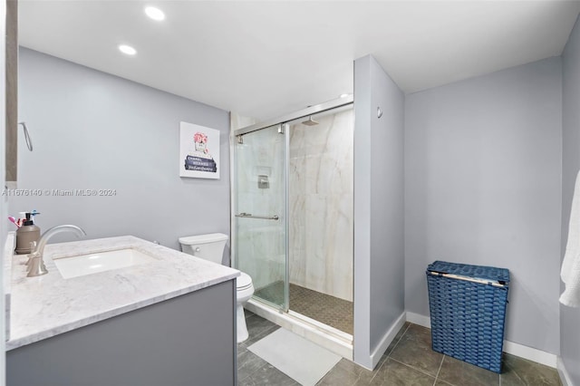 bathroom with vanity, toilet, an enclosed shower, and tile patterned floors