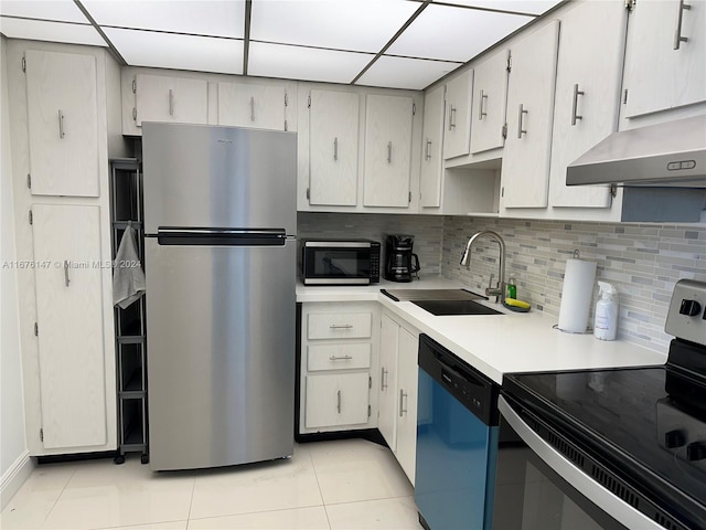 kitchen featuring sink, electric range oven, black dishwasher, stainless steel fridge, and light tile patterned floors