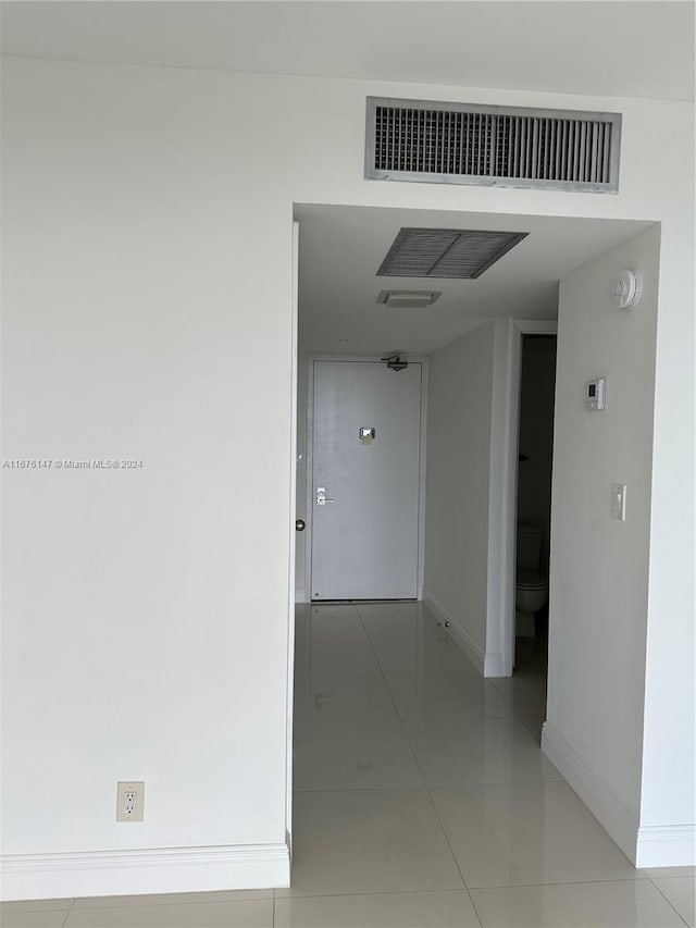 corridor with light tile patterned floors